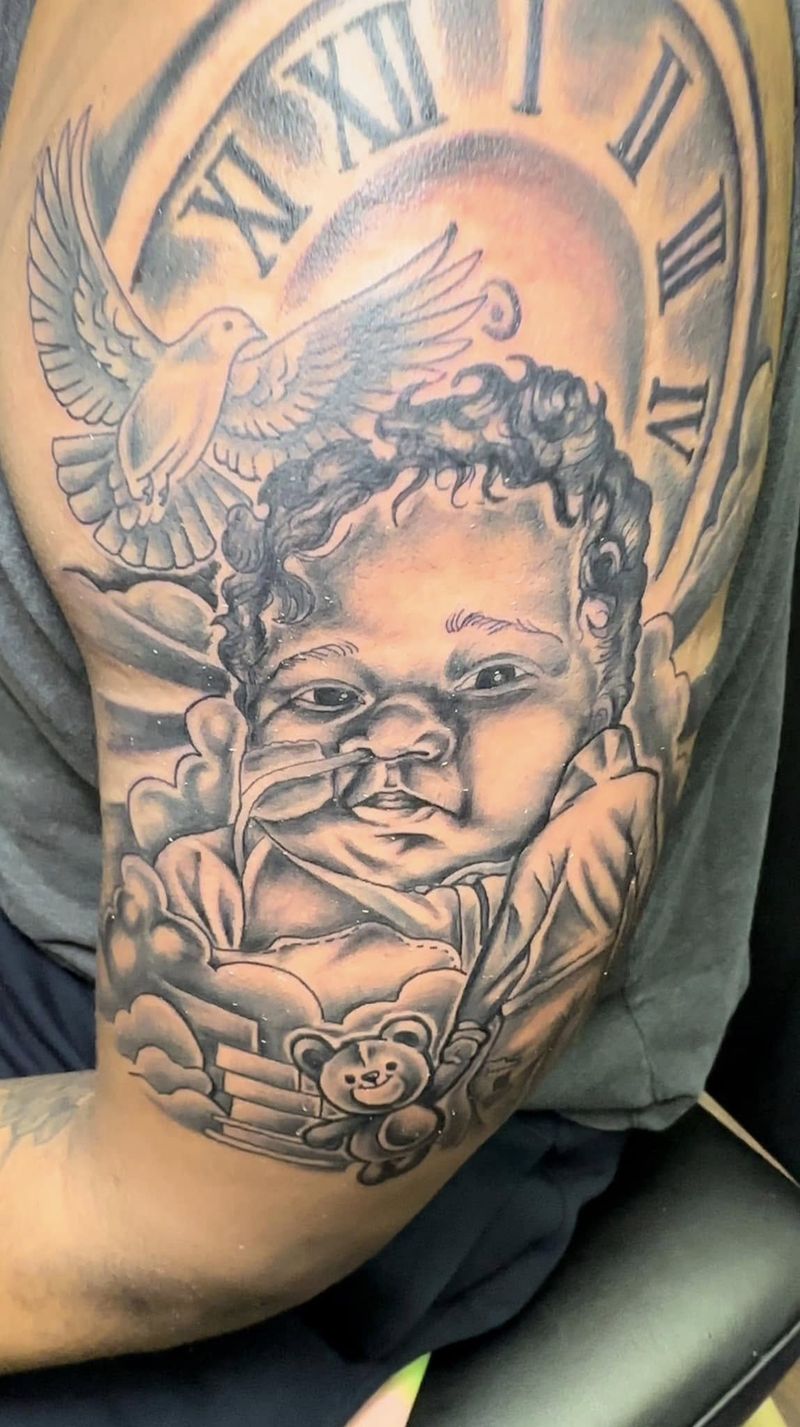 Black and grey tattoo of a baby portrait beneath a dove and a Roman numeral clock face on an upper arm.